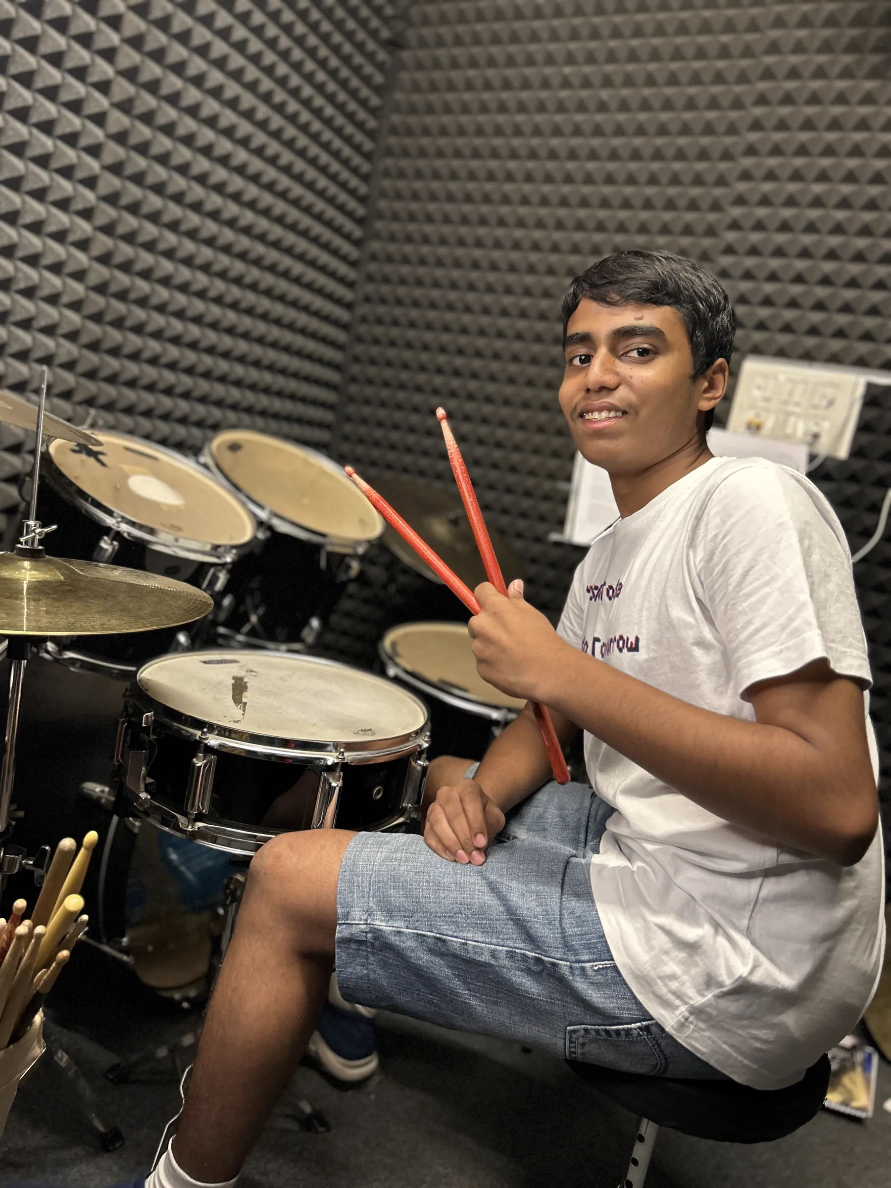 Student at a drum kit at DSM